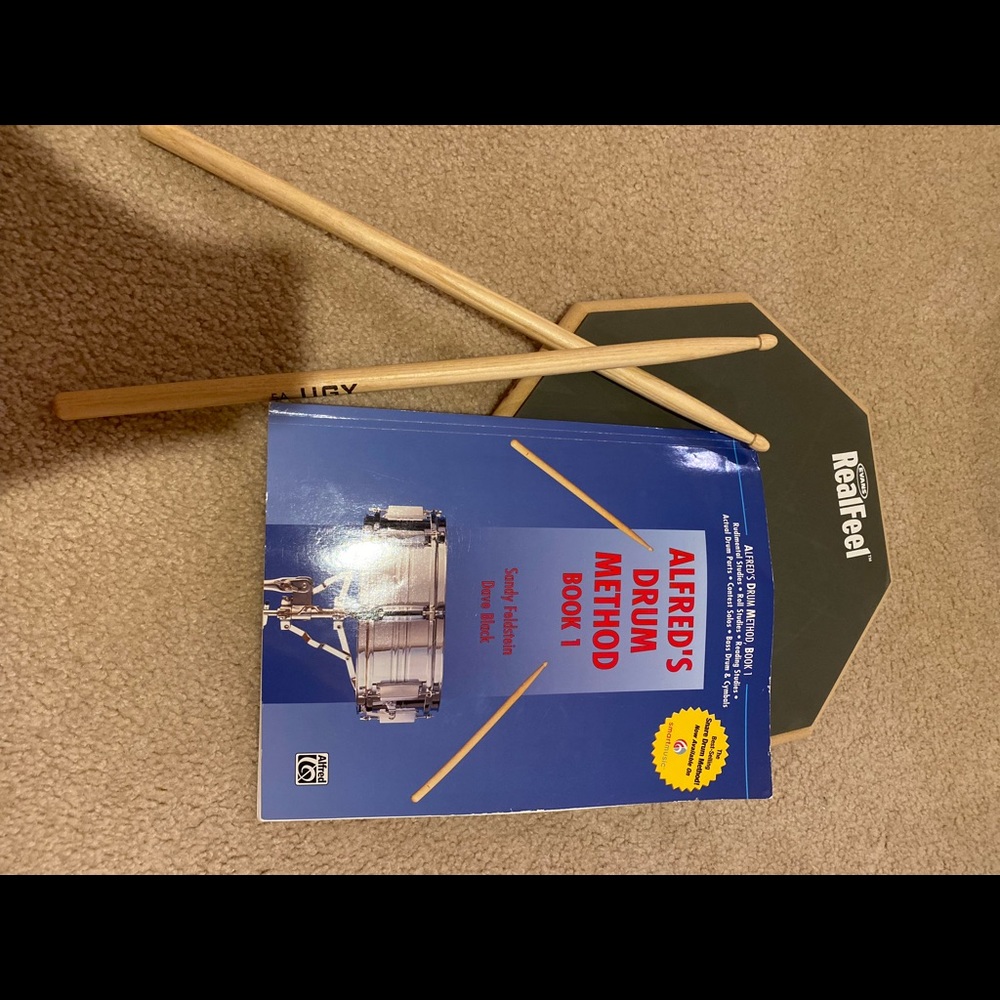 Drum pad, sticks and book